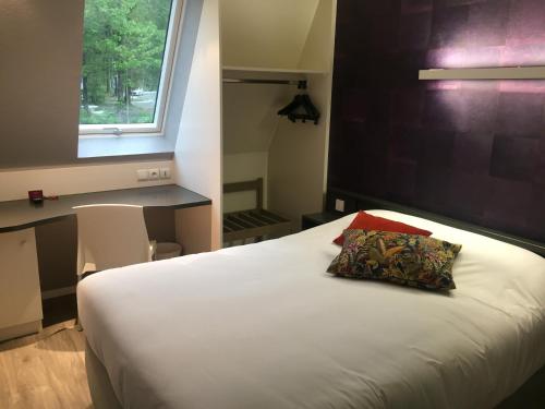 1 dormitorio con cama blanca y almohada en Acanthe hotel, en Erbrée