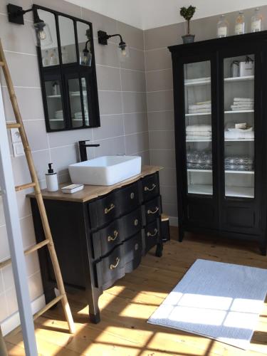 a bathroom with a sink and a wooden ladder at La Parenthese in Montreuil-sur-Mer