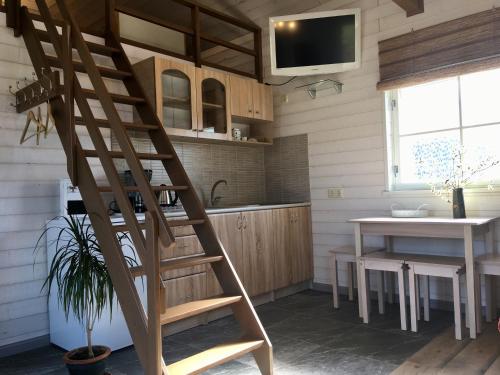 a wooden ladder in a kitchen with a table at Heinaka Kodu in Rakvere