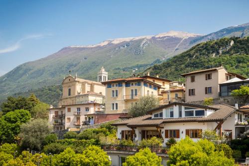 a group of houses in front of a mountain at Hotel Vega in Malcesine