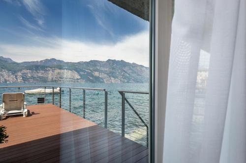 a balcony with a view of the water at Hotel Vega in Malcesine