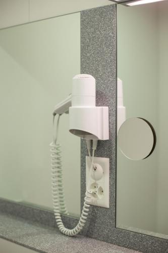 a white phone is hanging on a wall at Hotel Resslirytti in Basel