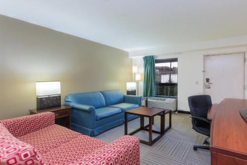 a living room with a couch and a table at Nations Inn - West Jefferson in West Jefferson