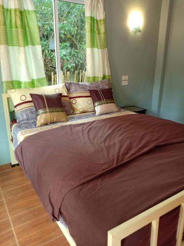 a large bed in a room with a window at Chandra Hostel Koh Tao 1 in Ko Tao