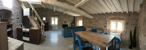 a dining room with a wooden table and blue chairs at Inside the Wall in Lucca