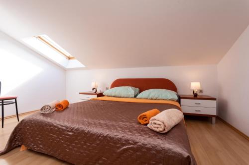 una camera da letto con un letto con asciugamani sopra di Apartmani Velnic a Baška