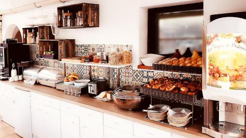 a kitchen filled with lots of different types of food at Hôtel Du Golfe in Sartène