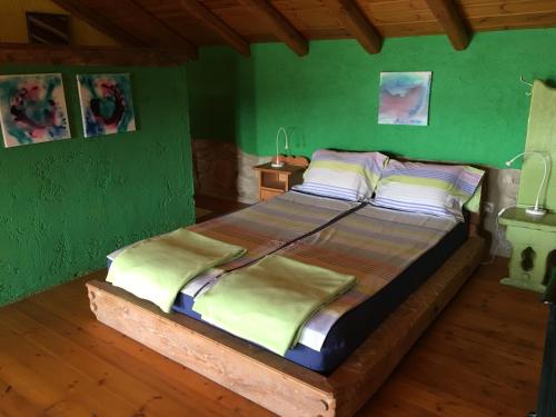 a bedroom with a large bed with green walls at Spiti Anne in Makrádes