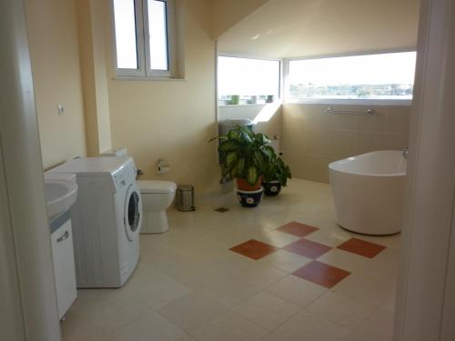 a bathroom with a tub and a toilet and a sink at Villa Alba in Preveza