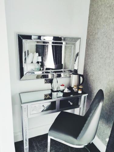 a desk with a chair in front of a mirror at Serendipity House in Derry Londonderry