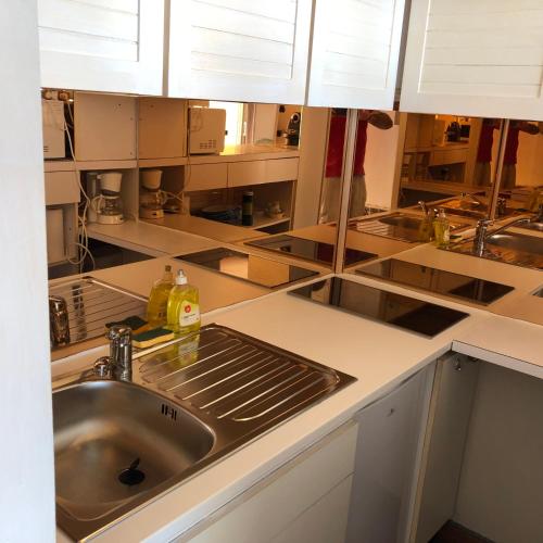 a kitchen with a sink and a counter top at Studio Face Ocean in Lacanau