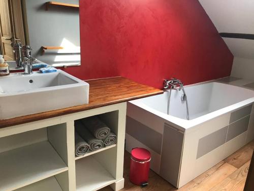 a bathroom with a sink and a bath tub at La Yonnaise in La Roche-sur-Yon