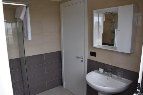 bagno con lavandino e doccia con specchio di Appartamento Flora a Gallipoli