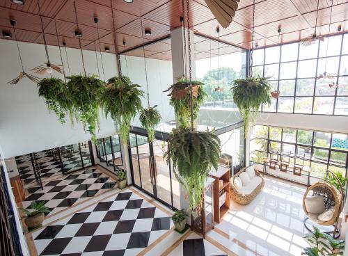 a room with plants hanging from the ceilings at Socool Grand Hotel in Nang Rong