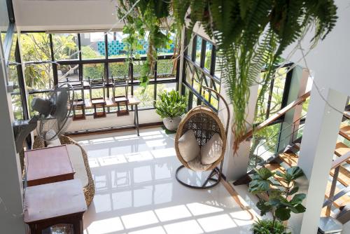 a balcony with rattan chairs and plants and a view at Socool Grand Hotel in Nang Rong
