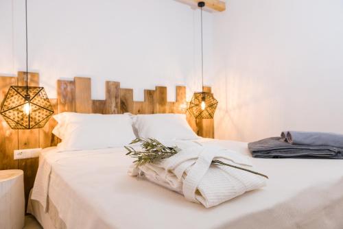 a bedroom with a white bed with two lights at Iris villa in Koundouros