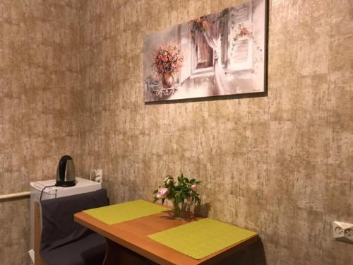 ein Zimmer mit einem Tisch und einem Gemälde an der Wand in der Unterkunft 1 ком квартира с газом вблизи ЖД вокзала in Odessa