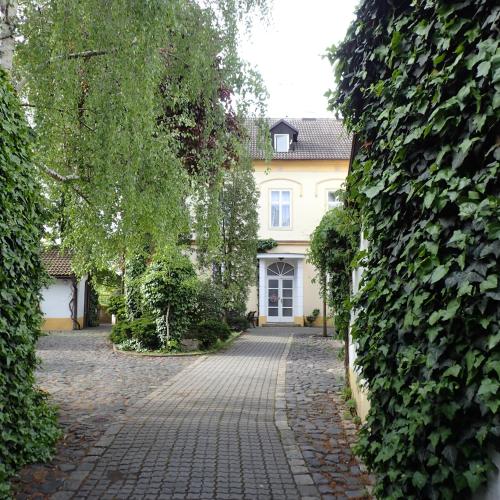 a cobblestone driveway in front of a house at Pension Prislin in Litoměřice