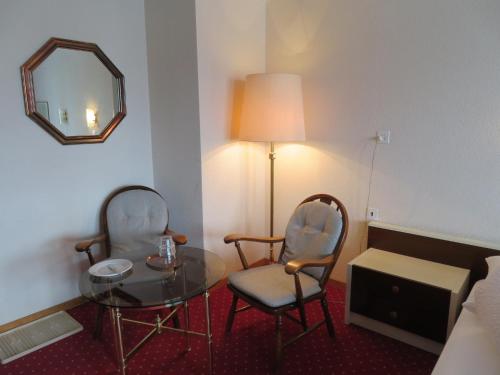 a room with a table and two chairs and a mirror at Landhaus an der Thur in Alt Sankt Johann