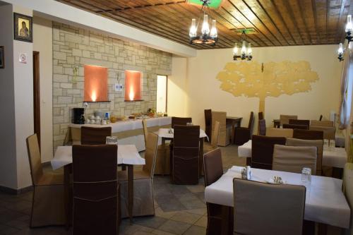 a restaurant with tables and chairs in a room at Agnantio in Ioannina