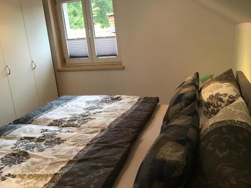 a bed in a room with a window at Haus Manuela in Velden am Wörthersee