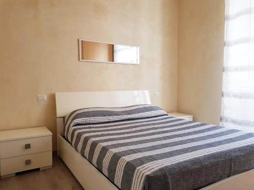 a small bedroom with a bed and a window at Casa Luciana in Savona