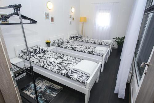 eine Gruppe von 3 Betten in einem Zimmer in der Unterkunft Apartman ART in Bihać