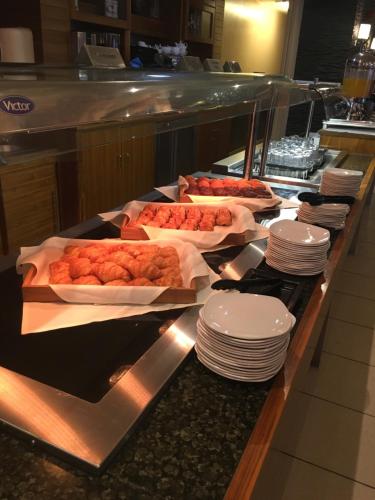 a buffet line with plates and food on at The Big Blue Hotel - Blackpool Pleasure Beach in Blackpool
