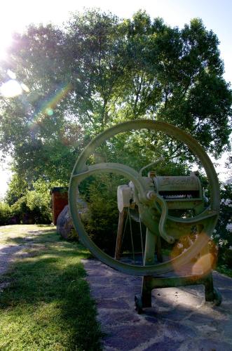 a large circular object is sitting on a bench in the grass at Podere Pinzicalari in Castel del Piano