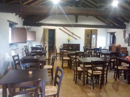 a dining room filled with tables and chairs at Agriturismo La Caraffara sull' Etna in Puntalazzo