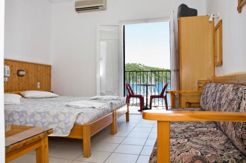 a hotel room with a bed and a balcony at Hotel Christina in Skiathos Town