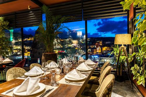 a table in a restaurant with a view of the city at Carus Cappadocia in Goreme