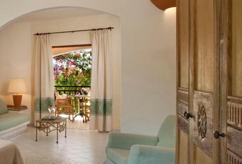 a living room with a couch and a table at Resort Cala Di Falco in Cannigione