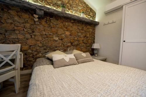 a bedroom with a bed and a stone wall at Cannes croisette in Cannes