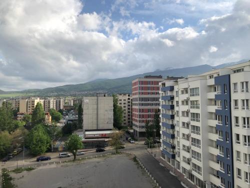 a view of a city with buildings and mountains at Bluemarine Apartment in Sofia