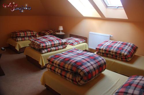 a room with four beds and a skylight at Ostoja Jurajska in Hucisko