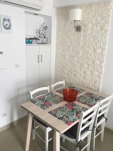 a dining room table with chairs and a bowl on it at Apartment Milena in Drasnice