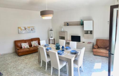 a living room with a dining room table and chairs at Parco Adamantina di Fronte al Mare in Diamante