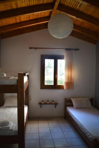 a bedroom with two bunk beds and a window at Poseidon Apartments in Gythio