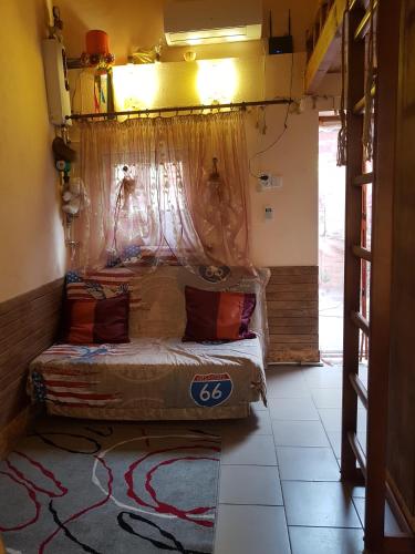 a bedroom with a bed with a mosquito net over it at Гостьовий дім, приватний сектор in Odesa