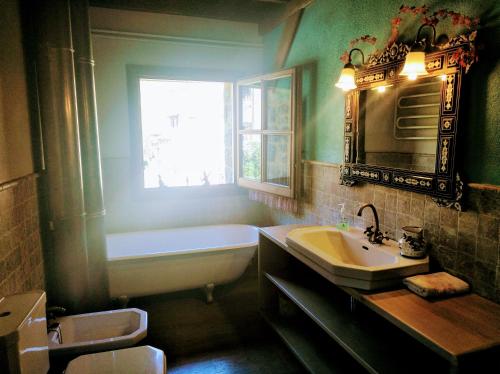 a bathroom with a tub and a sink and a bath tub at Bed&Breakfast la Cabanya de Beget in Beget