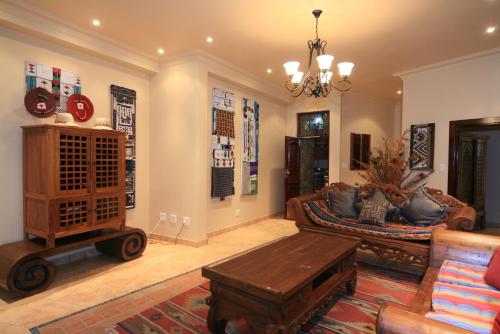 a living room with a couch and a table at AmmaZulu African Palace in Kloof
