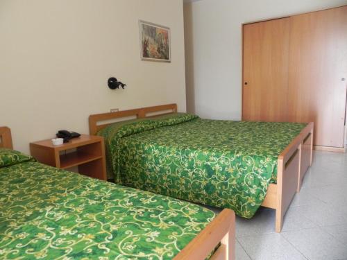 Postel nebo postele na pokoji v ubytování Albergo Sant'Anna