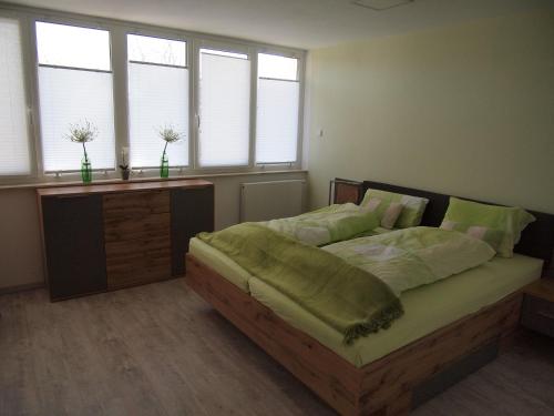 a bedroom with a large bed in a room with windows at Zuhause auf Zeit in Werther