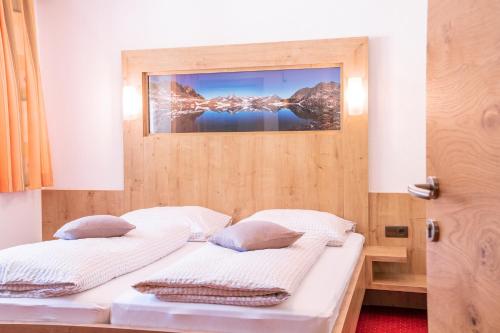 dwa łóżka w pokoju z obrazem na ścianie w obiekcie Appartement Holzknecht w Solden