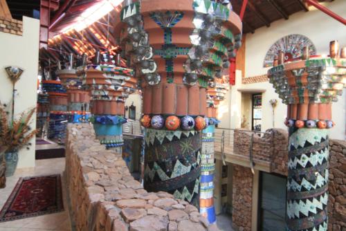 a store filled with lots of colorful vases at AmmaZulu African Palace in Kloof