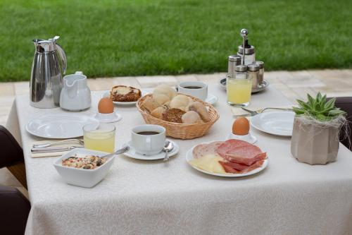 a table with breakfast foods and drinks on it at Pension Sattlerenglhof in Laces