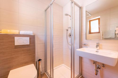 a bathroom with a shower and a sink and a toilet at Appartement Holzknecht in Sölden