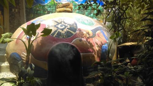 a large object with a painting on it in a garden at Temazcal Hospedaje "gema" adults only in Tepoztlán