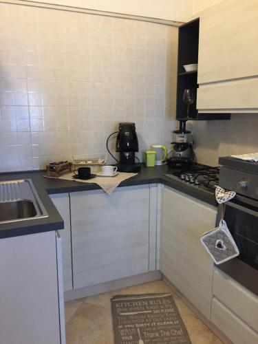 a small kitchen with a sink and a stove at Casa Cassiopea Céglie Messapica in Ceglie Messapica